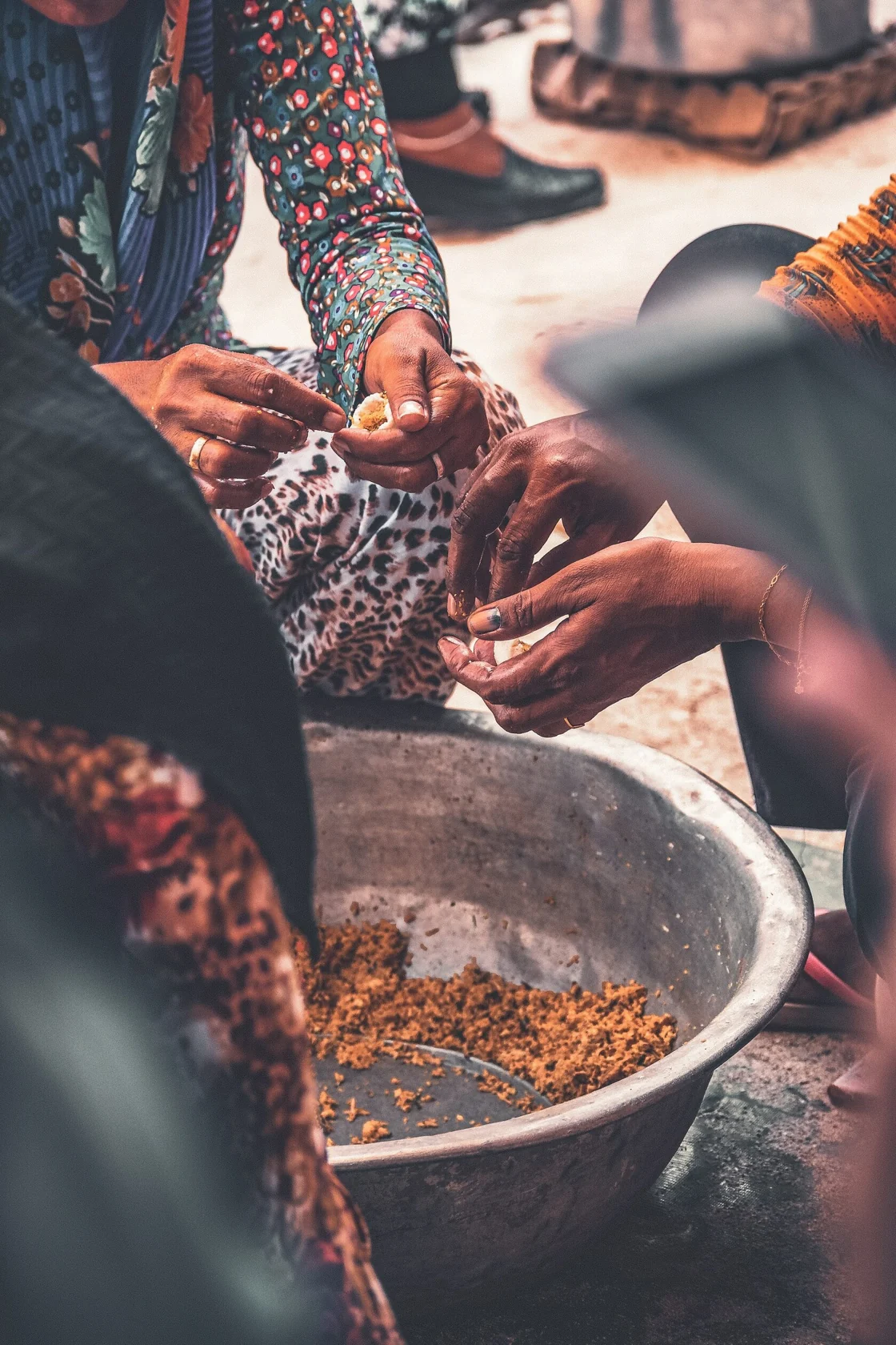 Maldivian islanders preparing food together by hand